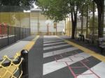 Asphalt play area with half-court basketball